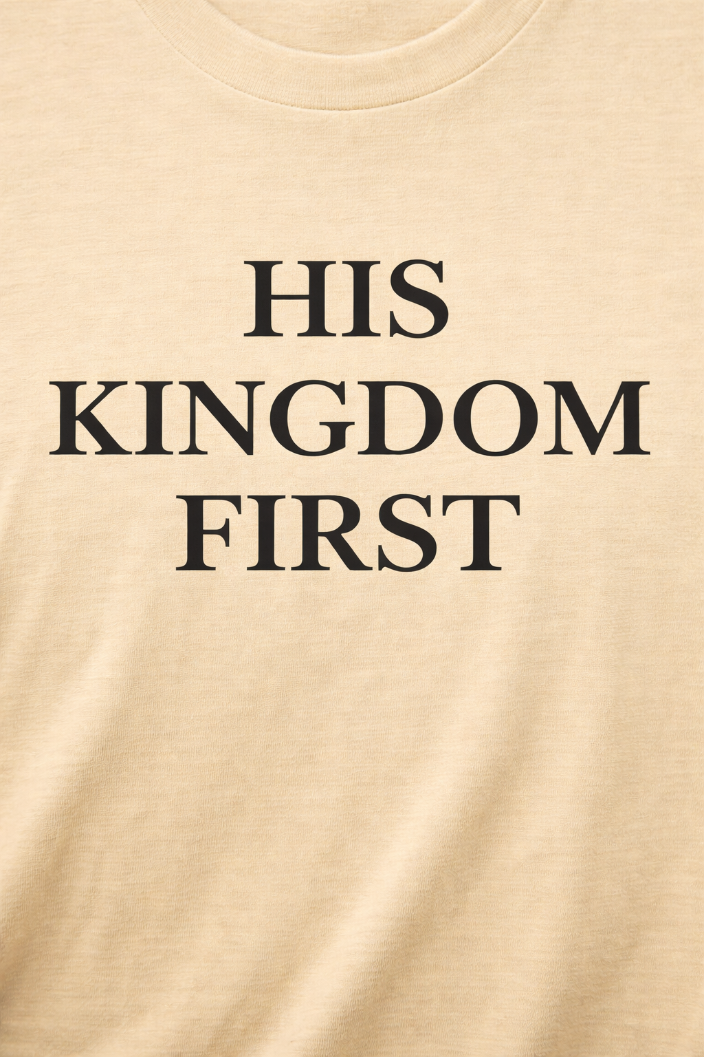 Close-up of “His Kingdom First” print on cream Christian t-shirt
