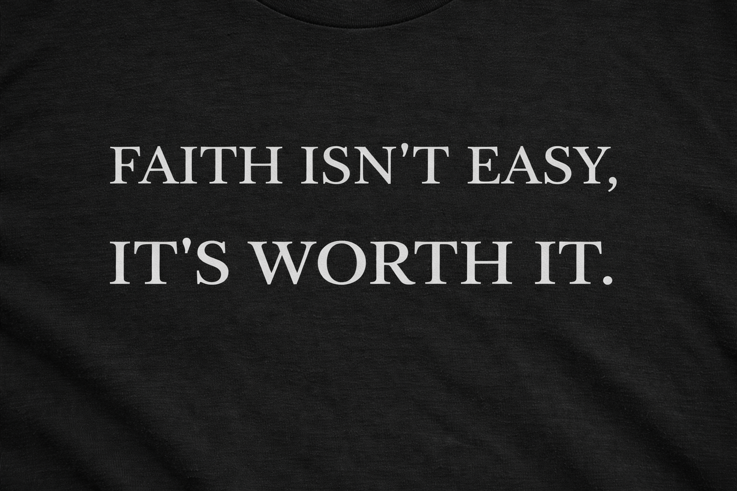 Close-up of “Faith Isn't Easy It's Worth It” print on black Christian t-shirt
