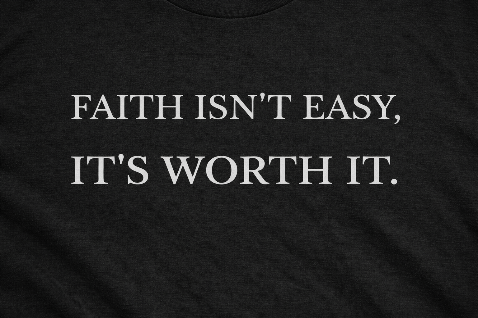 Close-up of “Faith Isn't Easy It's Worth It” print on black Christian t-shirt
