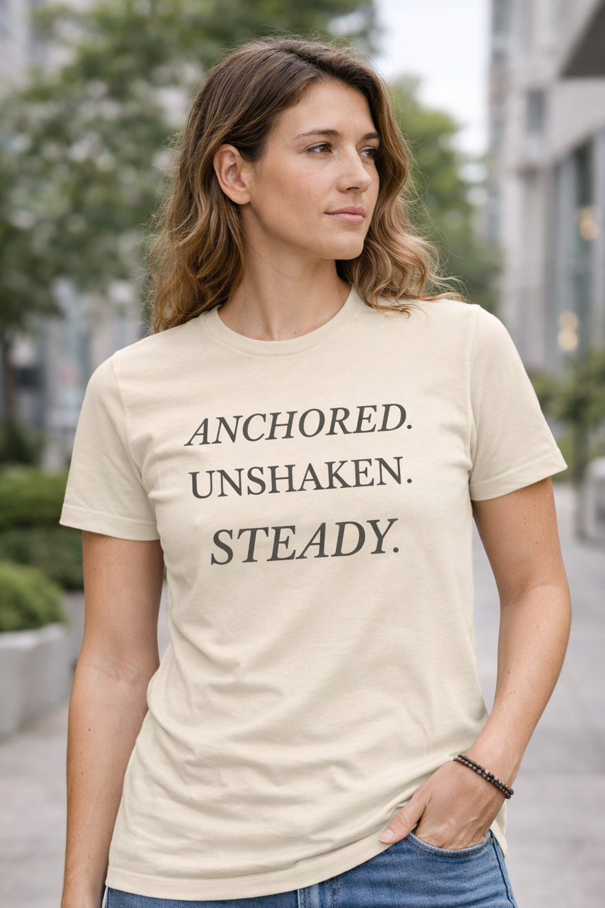 Anchored Unshaken Steady Christian t-shirt in cream worn by a woman outdoors
